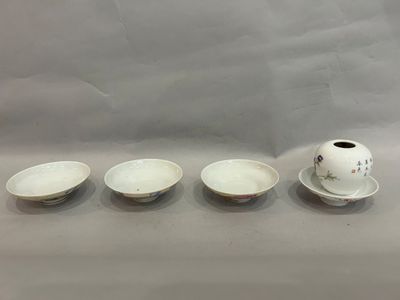 three small bowls and a small cup sit on a table