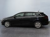 the black car is parked on the concrete floor in the room
