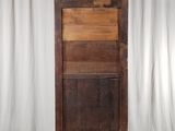 a tall wooden cabinet with a drawer on top of it