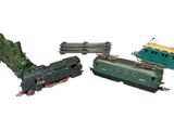 three toy trains sitting next to each other on a white surface