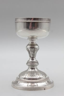 a silver cup on a pedestal on a white background