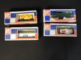 three boxed trains are sitting on a black surface