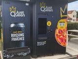 a pizza machine that is sitting on the side of the road