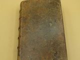 an old book sitting on a table on a table