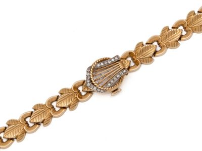 a close up of a gold and diamond bracelet on a white background