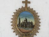 a picture of a cross hanging on a wall