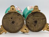 pair of gold and turquoise vases with floral designs on them