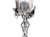 a silver cup with a lid on a stand