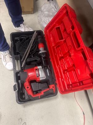 a red tool box with tools in it on the floor