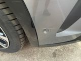 a close up of a car ' s front bumper and tire