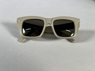 a close up of a pair of sunglasses on a white surface