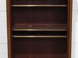 a large wooden bookcase with three shelves on top of it