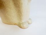 a close up picture of a cat statue on a white surface