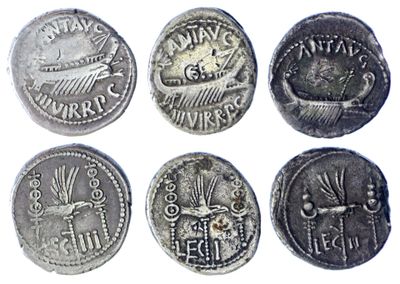 six ancient roman coins, one of which has been cleaned and the other of which has been cleaned