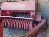 a red machine that is sitting in a barn