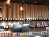 a photo of a coffee shop counter with a lot of bottles