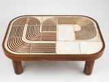 a close up of a wooden table with a geometric design on it