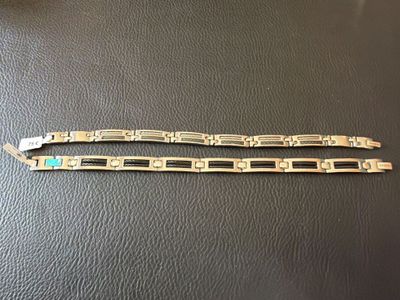 a pair of silver bracelets with turquoise stones on them