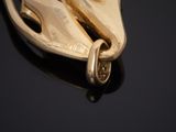 a close up of a pair of gold shoes on a black surface