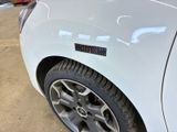 a close up of a white car with a sticker on the side of it