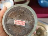 a person holding a bottle with a sticker on it