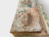 an old wooden box with a painting on it