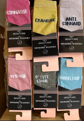 six pairs of men ' s socks in a display case