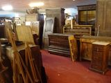 many pieces of furniture in a room with red carpet