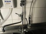 a faucet that is connected to a sink in the kitchen