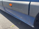 a close up of a blue truck with a red light on it