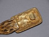 a gold cell phone with a chain attached to it