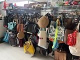 many bags hanging on a rack in a store