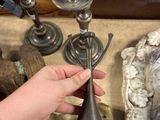 a person that is holding a metal object in front of other items