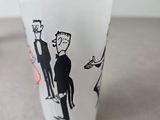 a shot glass with a picture of a man and a woman on it