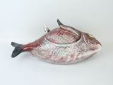 a fish shaped teapot sitting on a white surface
