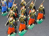 some figurines of men dressed in uniforms and holding swords