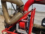 an image of a red machine with a hose attached to it