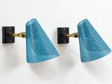 a pair of wall lights in the style of person