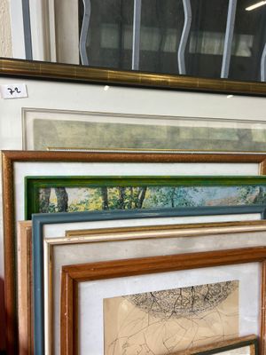 a lot of framed art on display in a room