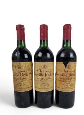 three bottles of red wine sitting next to each other on a white surface