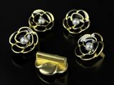 a set of five gold rings with pearls on a black surface