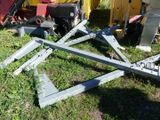 many pieces of metal sitting on the ground in the grass