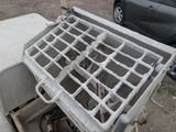 a metal grate on the ground next to a car