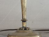 a gold table lamp that is on a marble table