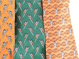 three different colored ties with a design on them on a white surface