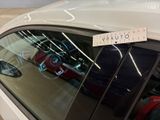 a sticker on the window of a car with luggage in it