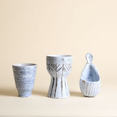 trois vases posés l'un à côté de l'autre sur une table