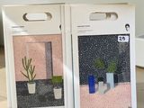 two boxes with plants on them sitting on a wooden table