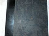 a black book on a white tablecloth with a note