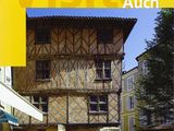 a yellow book cover with a picture of a building in the background